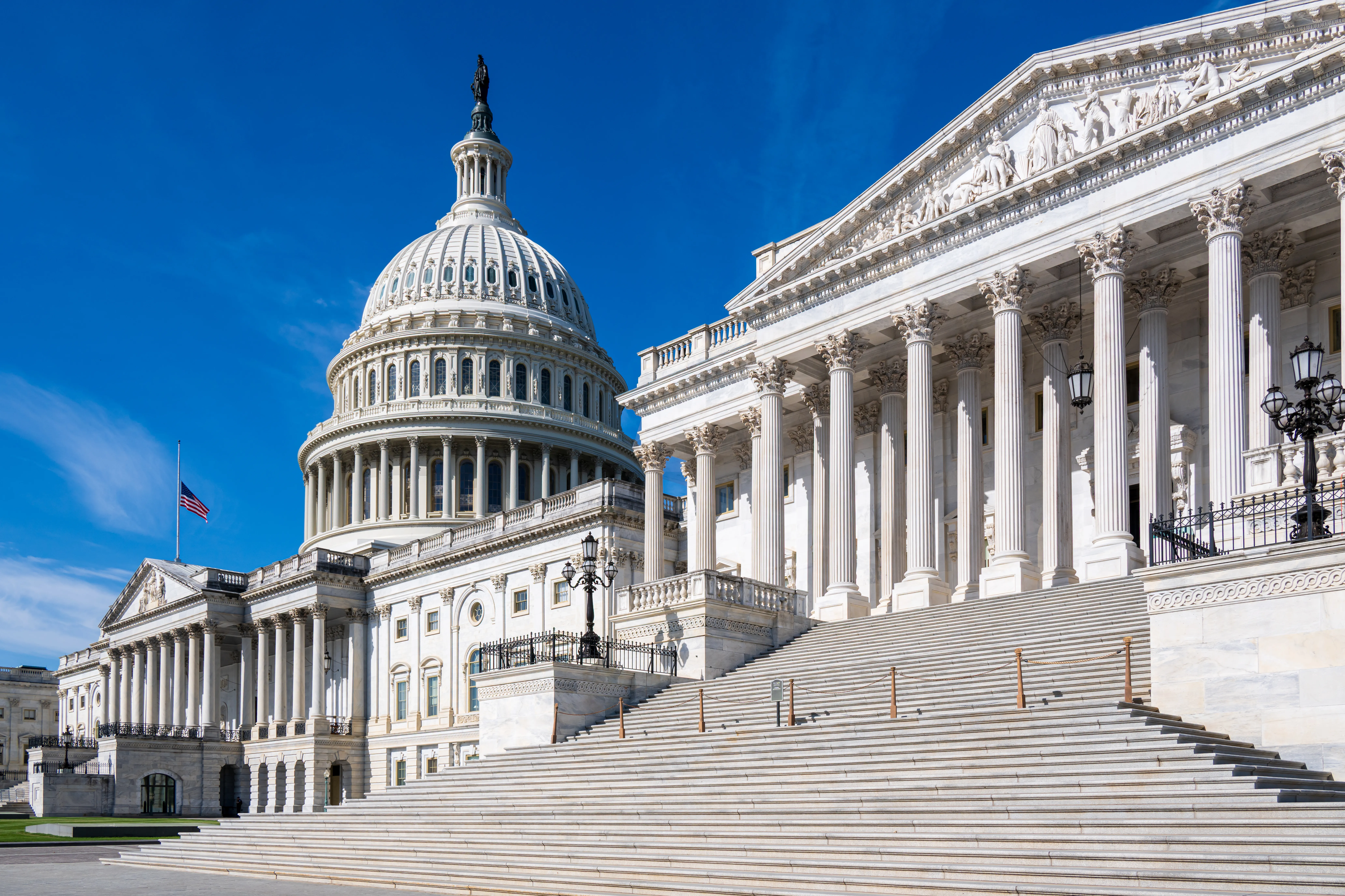 The United States Capitol building against a clear blue sky